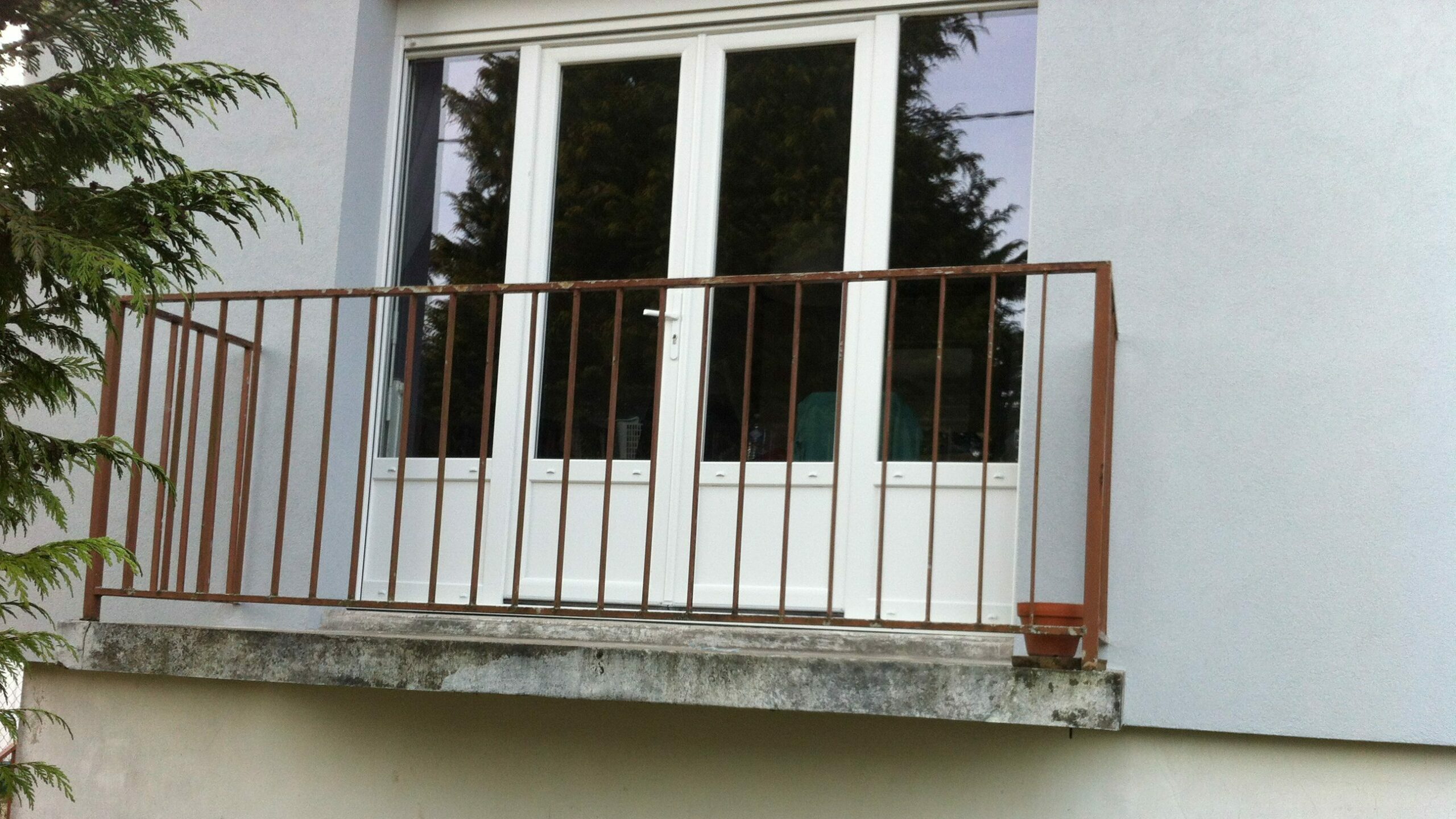 Porte-fenêtre en PVC blanc à deux vantaux et deux fixes sur balcon à Romilly-sur-Seine
