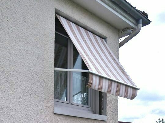 Store extérieur à projection installé sur fenêtre pour protection solaire